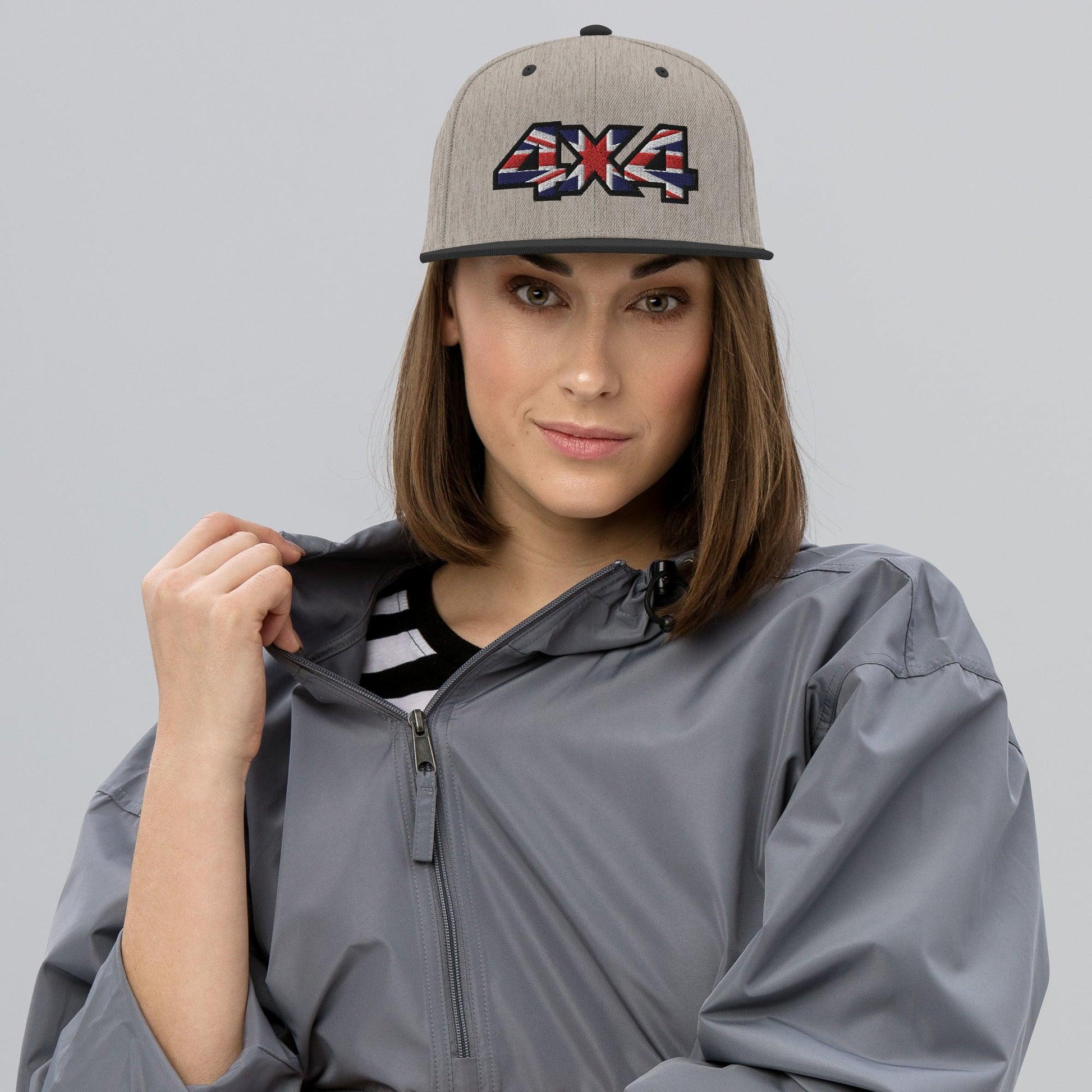 Woman wearing a heather grey and blue snapback hat