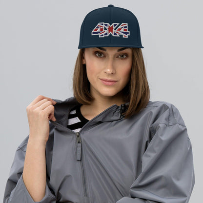 Woman wearing a navy blue and red classic snapback hat with a 4x4 UK decal embroidery