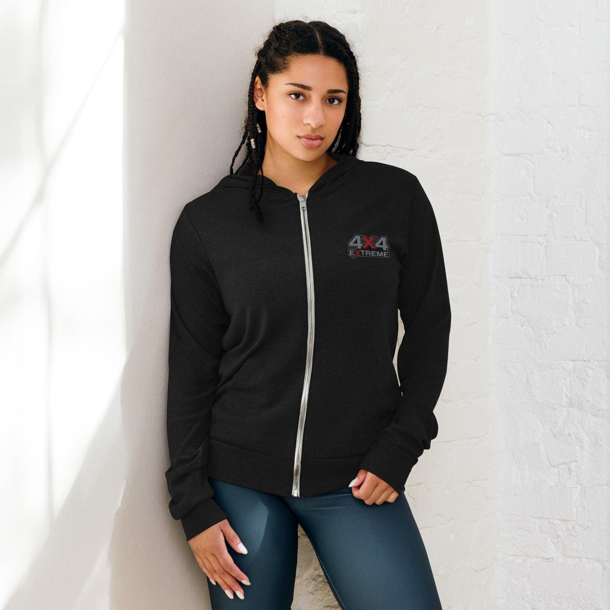 Woman wearing zip hoodie with silver and red embroidery